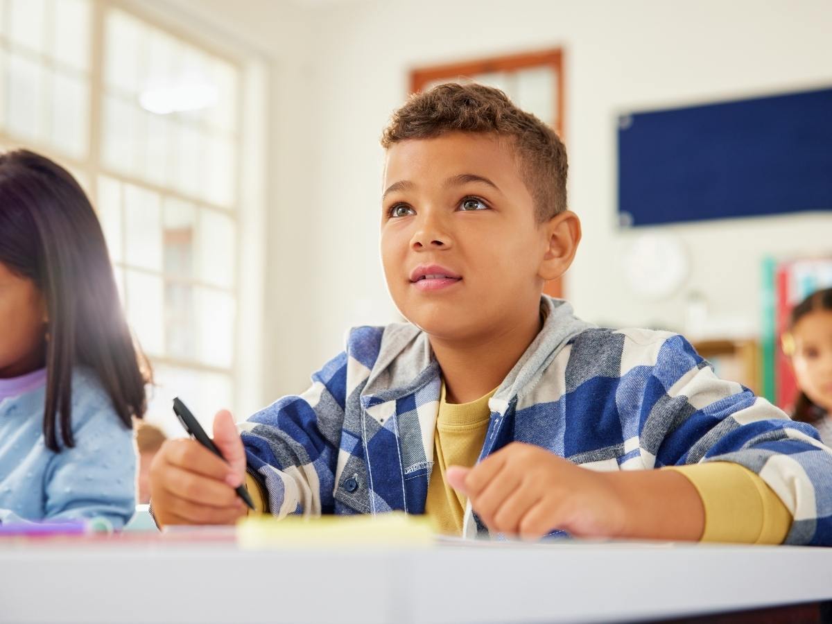 Focused boy during lesson in class for article Forest Grove School District for newcomers moving to Portland area.