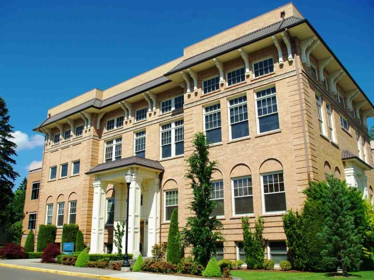 Wood-Mar Hall tall light colored rectangular building for article George Fox University for newcomers moving to Portland.