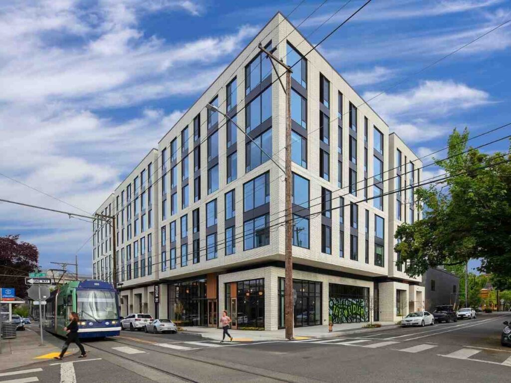 Image of The Weidler Apartment building with streets around it with TriMet transportation going by the building for article Looking to Rent in Portland? 8 Tips for Success for newcomers moving to Portland.
