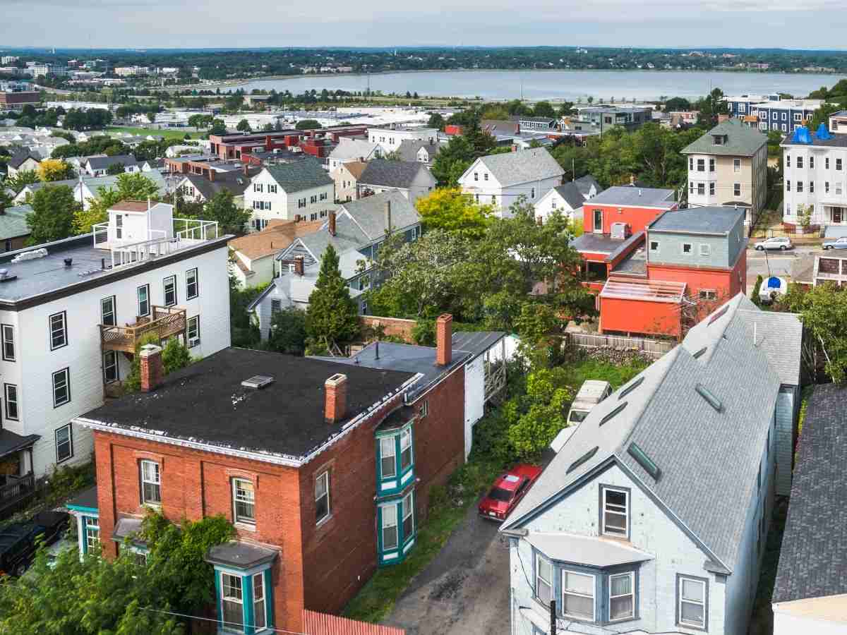 Aerial view of Portland, Oregon neighborhood with water in background for article Portland Makes Most Popular City To Live List for newcomers moving to Portland.