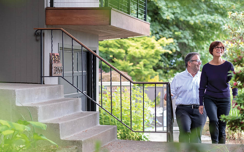 Man and woman walking up outdoor steps to front entrance of home for article Tips on Purchasing Your First Home in Portland for newcomers moving to Portland.