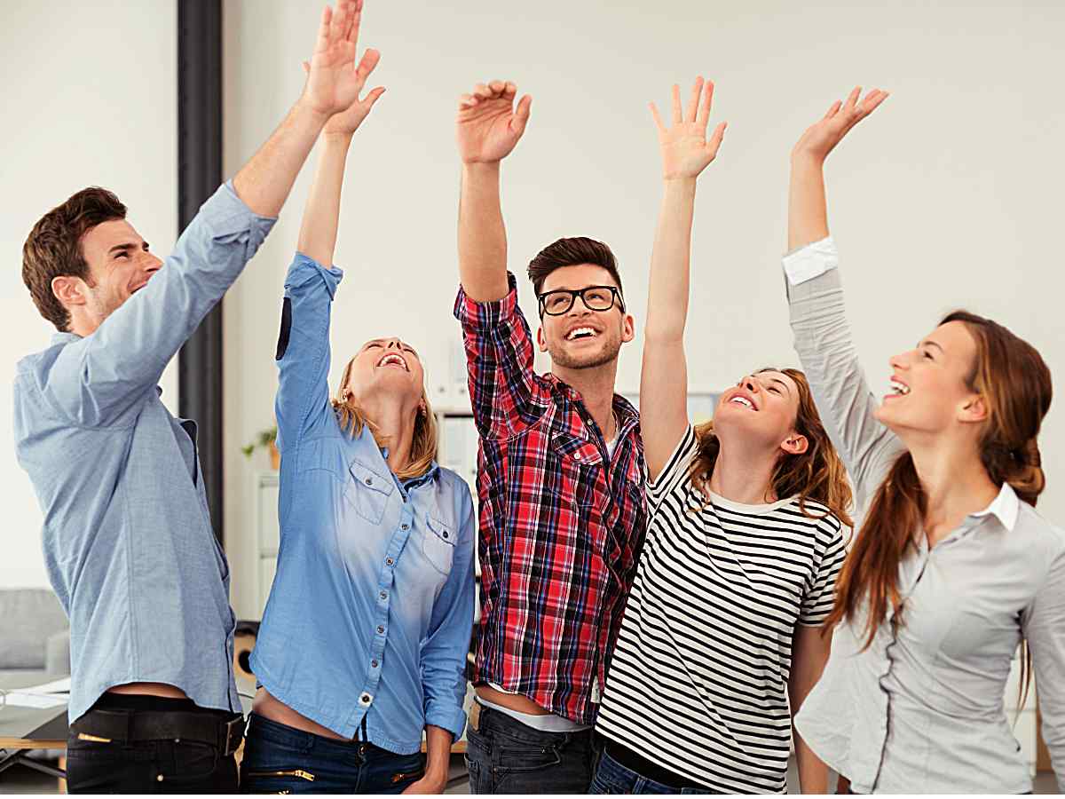 Coworkers cheering for article Portland Workplaces Employees Love for newcomers moving to Portland.