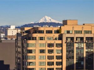 Image of Pearl District Apartment building with Mt hood in the background for article Top 10 City Neighborhoods in Portland for newcomers moving to Portland.