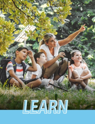 Female teacher with students out in nature with binoculars