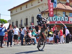 The Unipiper is a man riding a unicycle playing bagpipes with a Darth Vader mask on for article Keep Portland Weird: 10 Bizarre Things That Happen in PDX for newcomers moving to Portland.