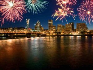 Fireworks over Portland bridge with skyline in background for article Best Places to Watch 4th of July Fireworks in Portland for newcomers moving to Portland area.