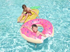 Two boys swimming in a pool