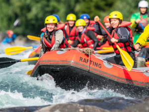 Group of people white water rafting.