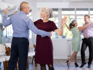 Senior adults learning to dance in a class.