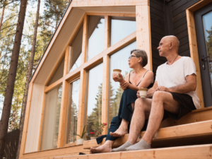 Senior couple sitting on front steps of home in Portland for article Retiring in Portland: 9 Best Places.